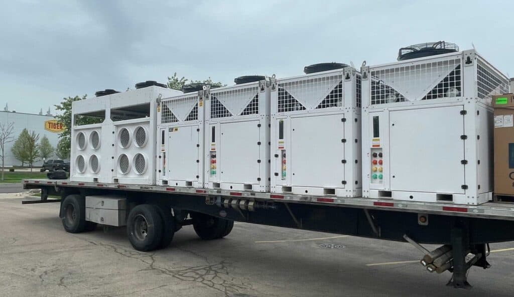 Large portable HVAC units on a flatbed truck for emergency cooling solutions.