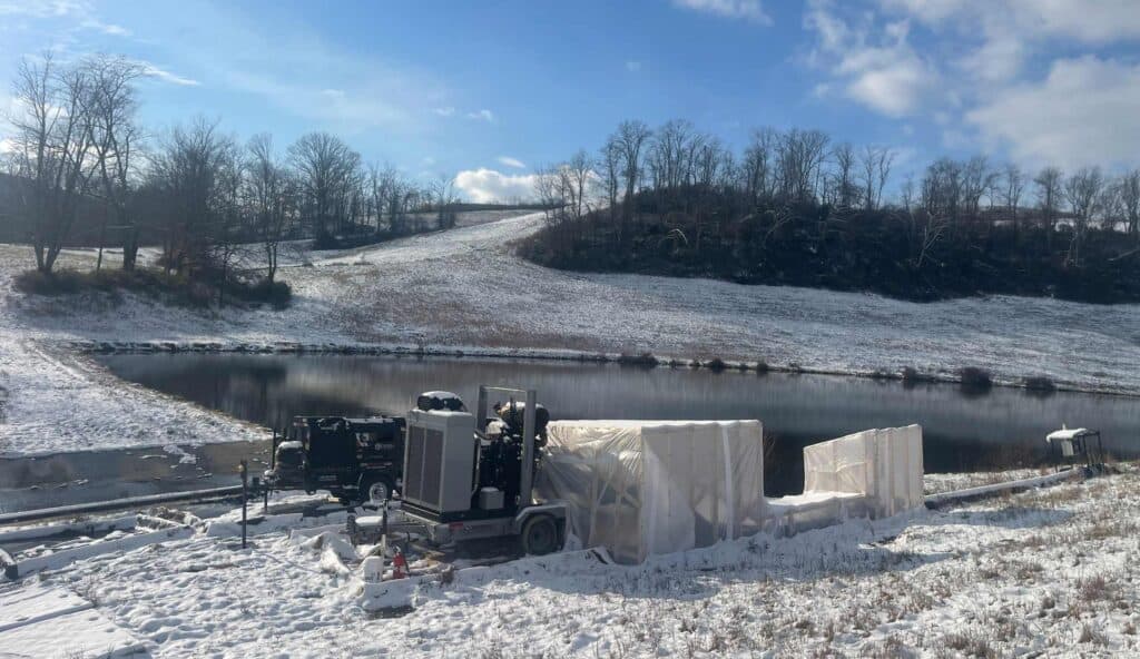 Industrial rental heater operating outdoors in snowy landscape.