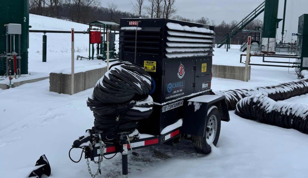 Portable construction heater on trailer in snowy outdoor setting.