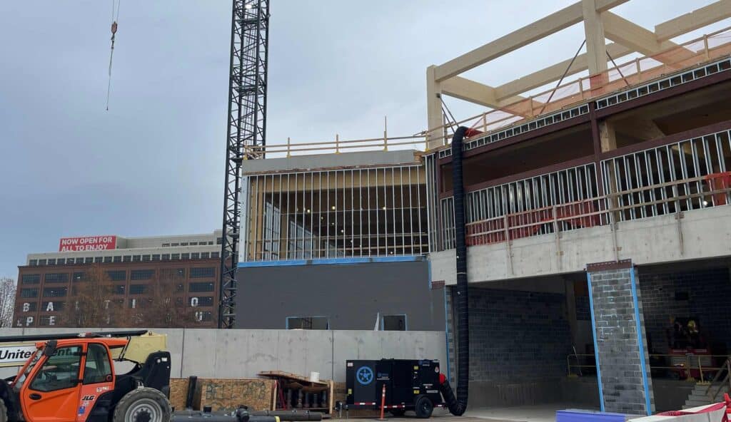 Hotel construction site with crane and building framework under development.